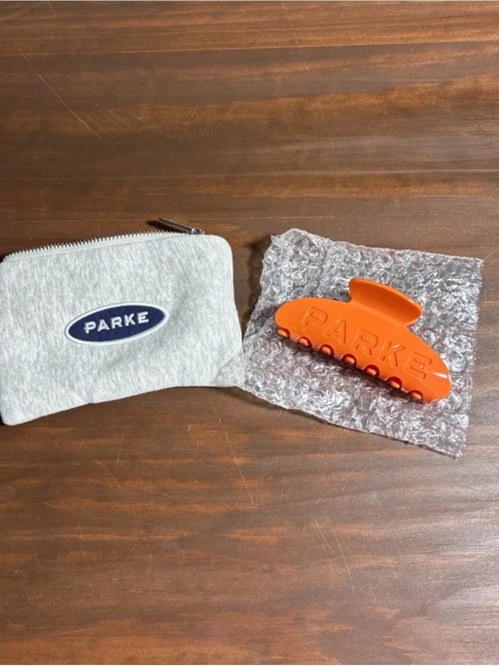 PARKE Orange Hair Claw Clip with Gray Logo Pouch